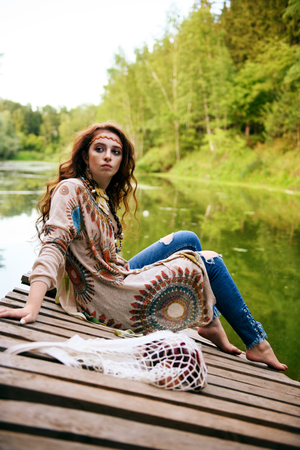 Beautiful hippie girl posing outdoor. Contemporary bohemian style. Spirit of freedom. Fashion shot. Bohemian, bo-ho style.の写真素材