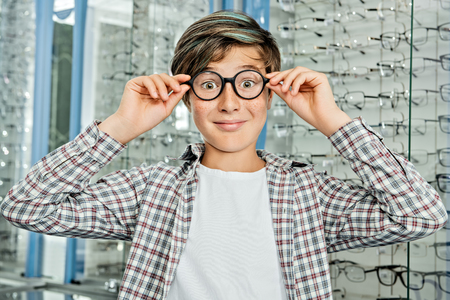 A portrait of a teenage boy. Optics, vision, healthcare.の写真素材
