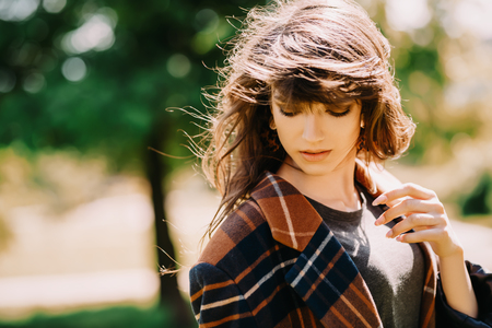 A portrait of a young woman in the park. Beauty, cosmetics, skin protection.の写真素材