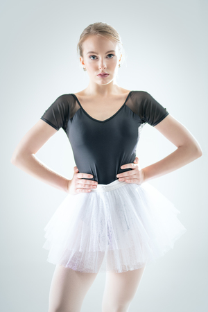 A portrait of an elegant refined ballet female dancer posing in the studio over the white background. Talent, beauty, fashion for ballet dancers.の写真素材
