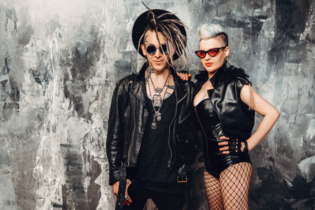 A portrait of two stylish punk people in the street. Modern men fashion, rock musicians.の写真素材