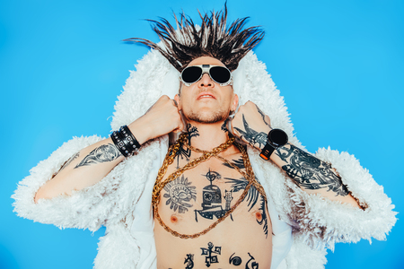 A portrait of a cool young punk man posing in the studio. Casual punk fashion, beauty.の写真素材