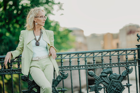 A portrait of an elderly stylish woman walking in the street. Beauty, city fashion.の写真素材