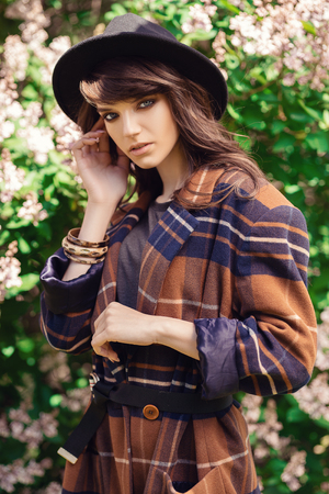 A portrait of a young fashionable woman in the park. Beauty, fashion.の写真素材
