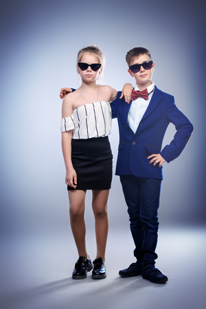 Young schoolchildren posing in a studio. Casual concept for kids.の写真素材