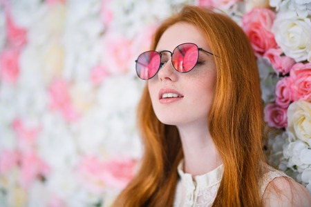 A close up portrait of a lovely beautiful girl in sunglasses. Beauty, cosmetics, optics.の写真素材