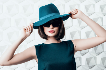 A close up portrait of a beautiful woman wearing a hat and sunglasses. Fashion, style, beauty, optics.の写真素材