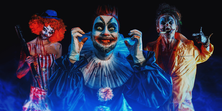 A portrait of three angry crazy clowns from a horror film. Halloween, carnival.の写真素材