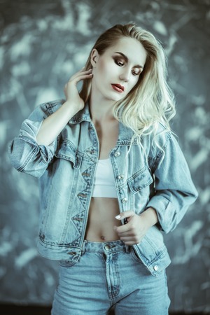 A portrait of a romantic young lady posing in the studio. Beauty, casual fashion.の写真素材