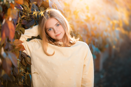 A portrait of a pretty young girl outside in autumn. Autumn fashion, beauty.の写真素材