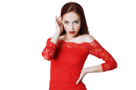 A portrait of a beautiful young woman in a red dress. Beauty, fashion.の写真素材