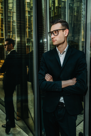 A portrait of a goodlooking young guy walking in the street. Men's beauty, fashion, business.の写真素材