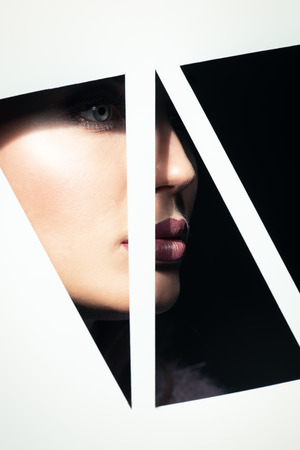 Beautiful lady looking from behind background. Beauty, make up.の写真素材