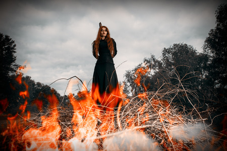 A portrait of an angry witch tied for incineration. Magic, dark force, spell.の写真素材