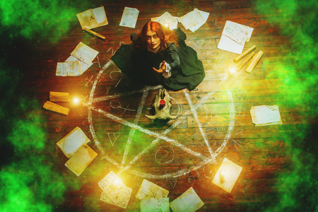 A portrait of a scary witch in the wooden house. Magic, dark force, spell.の写真素材