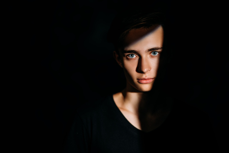 A portrait of a young goodlooking guy in a black t-shirt. Beauty of men, casual fashion.の写真素材