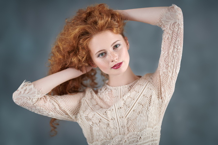 Beautiful young woman with long red hair. Hair care, hair coloring.の写真素材