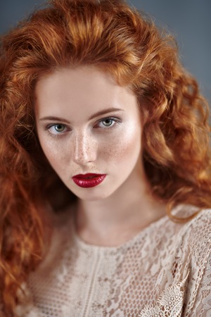 Beautiful young woman with long red hair. Hair care, hair coloring.の写真素材