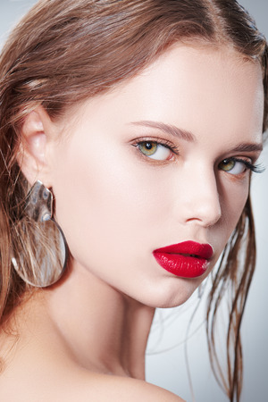 Healthcare and beauty concept. Close-up portrait of a beautiful young woman with fresh healthy shining skin. Facial skin care, cosmetology.の写真素材