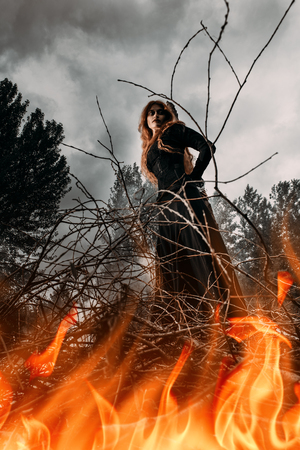 A portrait of an angry witch tied for incineration. Magic, dark force, spell.の写真素材