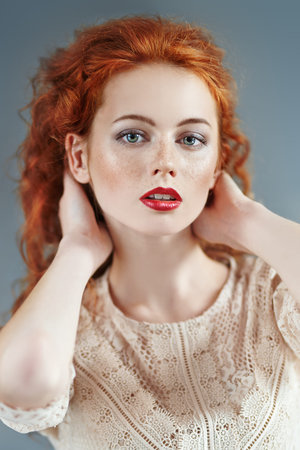 Beautiful young woman with long red hair. Hair care, hair coloring.