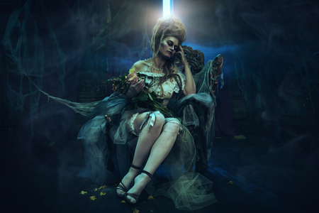 Halloween. Portrait of the dead empress in the old abandoned castle. Ghost in the castle. Vintage style.の写真素材