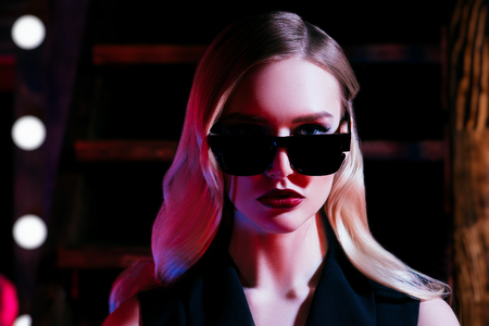 A portrait of a confident lady wearing sunglasses. Beauty, make-up, style.の写真素材