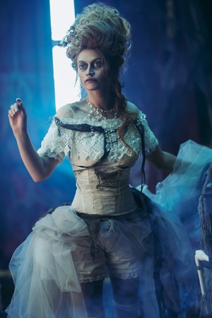 Halloween. Portrait of the dead empress in the old abandoned castle. Ghost in the castle. Vintage style.の写真素材