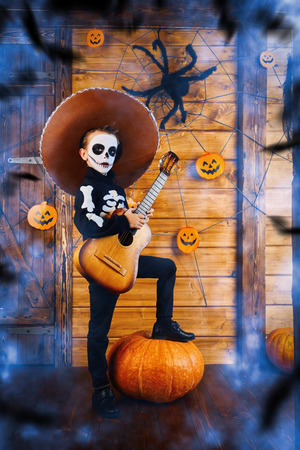 Sugar skull child boy in an old wooden house. Dia de los muertos. Day of The Dead. Halloween.の写真素材