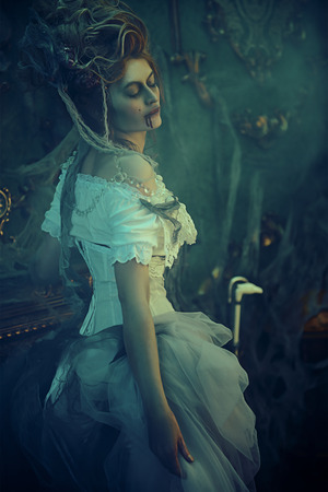 Vampires. Charming and terrible vampire woman in the old abandoned castle. Vintage style. Halloween.の写真素材