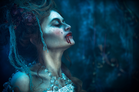 Vampires. Bloodthirsty female vampire in the old abandoned castle. Vintage style. Halloween.の写真素材