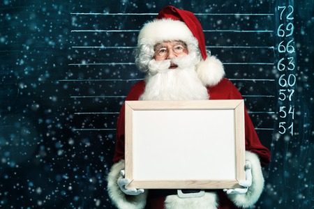 A portrait of Santa Claus in sunglasses holding a plate. Merry Christmas and Happy New Year!の写真素材