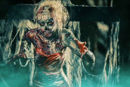 Dead bride woman on an abandoned cemetery. Zombie bride. Halloween.の写真素材