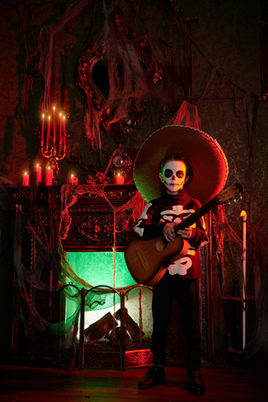 Sugar skull child boy in an old magic castle. Dia de los muertos. Day of The Dead. Halloween. Fairy tales. Children's horror stories.の写真素材