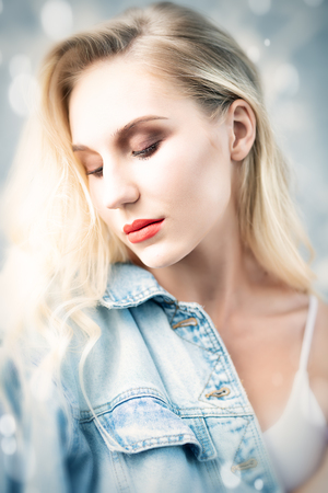 A portrait of a romantic young lady posing in the studio. Beauty, casual fashion.の写真素材