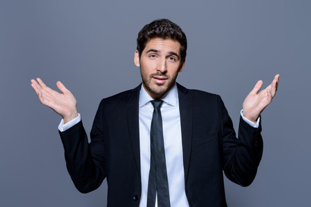 Emotional businessman pulls his hands apart, expressing surprise and disappointment. Business...