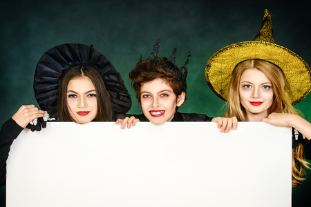 Funny children in carnival costumes on halloween. Halloween party with pumpkins.の写真素材