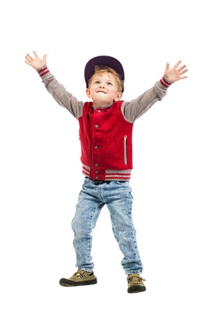 A full length portrait of a happy young schoolboy posing in the studio over the white background. Kids casual fashion, education.の写真素材