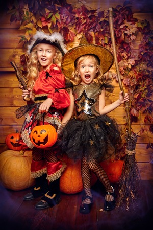 Halloween party. Joyful kids celebrate Halloween with fun. Halloween decorations with pumpkins.の写真素材
