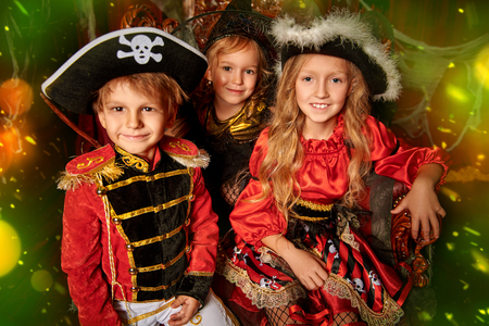 Children in carnival costumes celebrate Halloween together in an old house. Halloween party.の写真素材