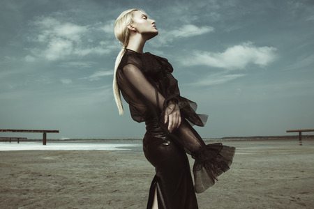 Portrait of a beautiful woman in black clothes posing outdoor. Beauty, fashion.の写真素材