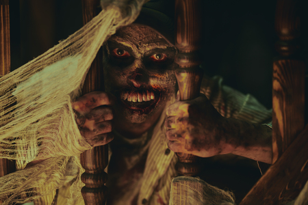 Scary bloodthirsty zombie man in a ruined building. Horror. Halloween.の写真素材