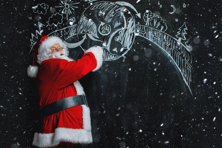 A portrait of Santa Claus standing in a classroom near the blackboard. Merry Christmas and Happy New Year!の写真素材