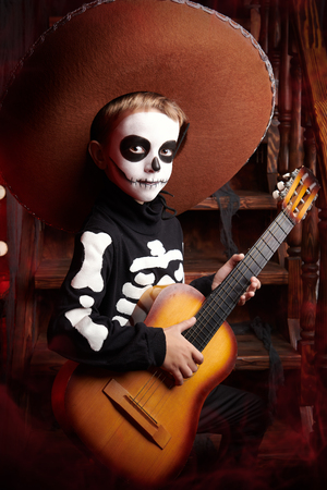 Sugar skull child boy in an old wooden house. Dia de los muertos. Day of The Dead. Halloween.の写真素材