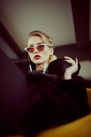 Stylish elegant businesswoman in interiors. Beauty, fashion. Optics and eyewear.の写真素材