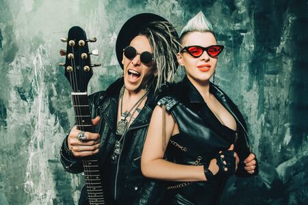 A portrait of two stylish punk people. Modern men fashion, rock musicians.の写真素材