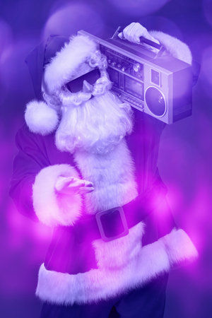 Cool DJ Santa Claus in sunglasses holds tape recorder on a festive background with lights. Christmas...