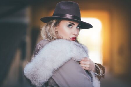 A portrait of a beautiful blonde lady walking in the street. Beauty, urban fashion, style.の写真素材