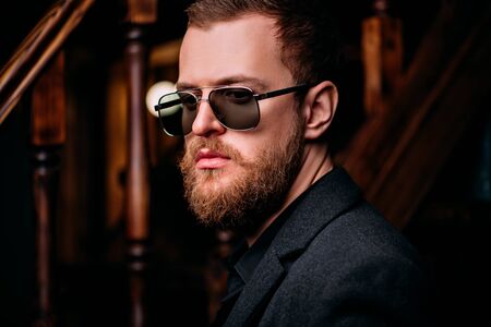 A portrait of a stylish man wearing sunglasses. Beauty and style for men.の写真素材