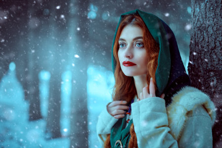 Portrait of a beautiful young woman with long red hair wearing medieval clothes walks through a winter snowy forest. Historical reconstruction of the early Middle Ages. Christmas tale.の写真素材